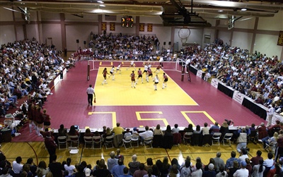 Indoor volleyball court with a red and yellow court. 