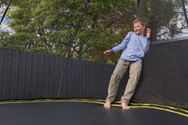 Black trampoline with a black net.