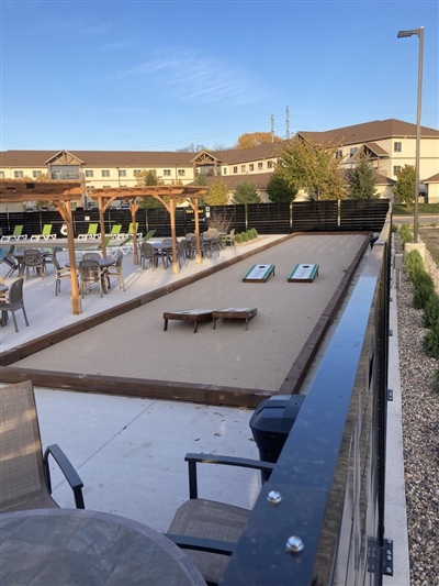 Multipurpose outdoor bocce ball court with a wooden border. 